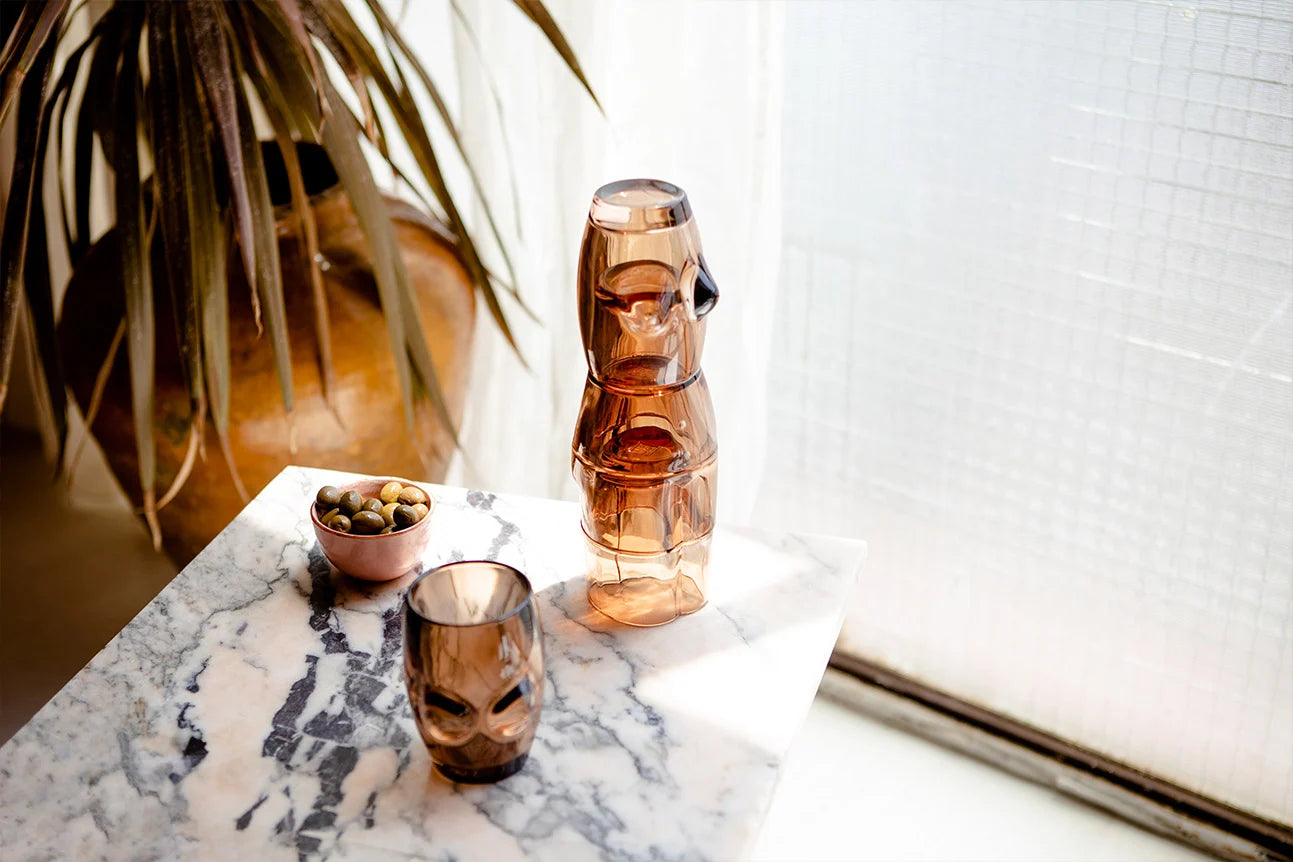glasses and olive bowl sitting on table
