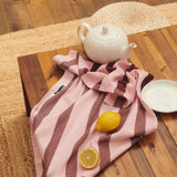 striped striped pink and red tea towel on floor scrunched up