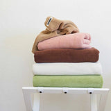 different coloured towels sitting in stack