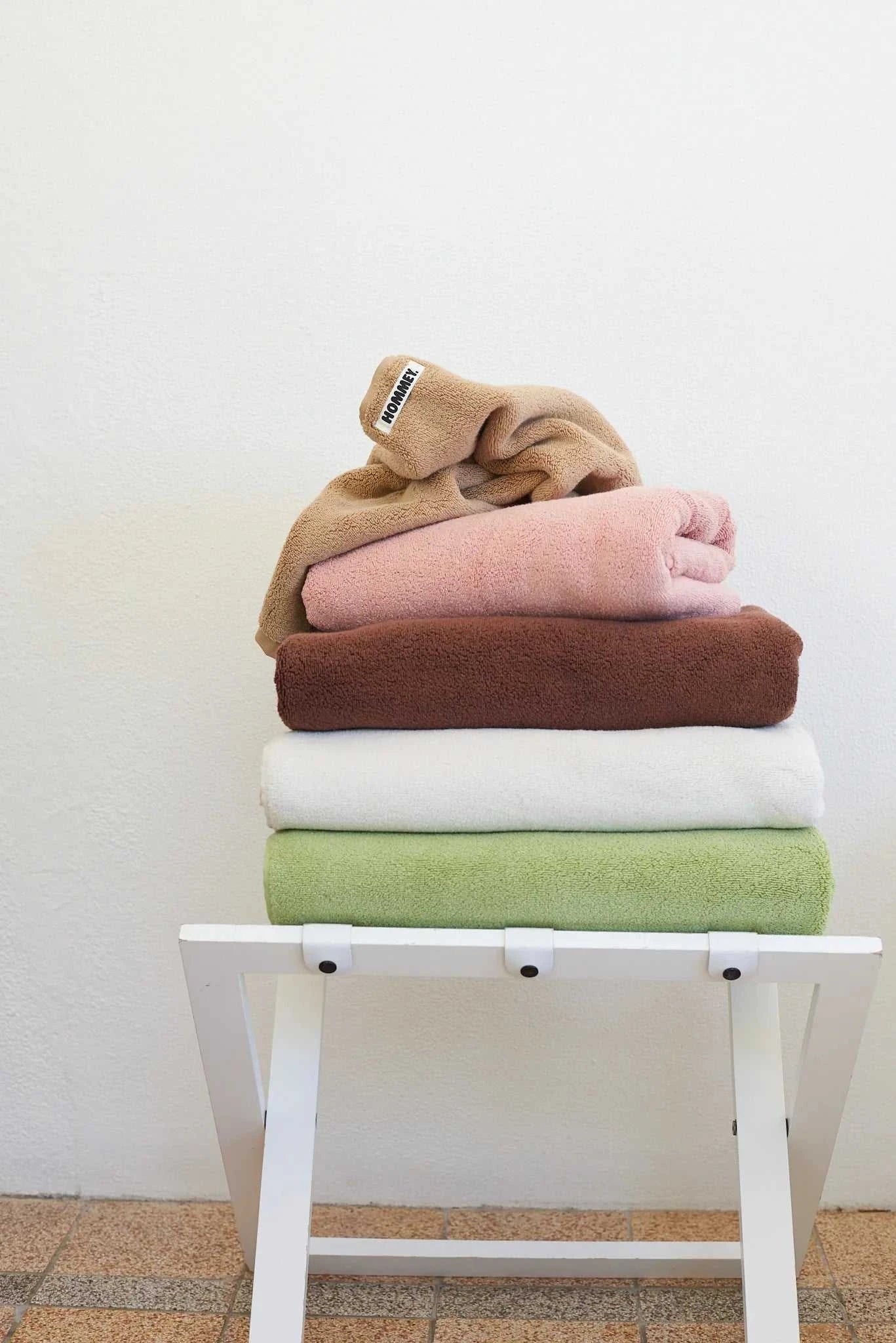 different coloured towels sitting in stack