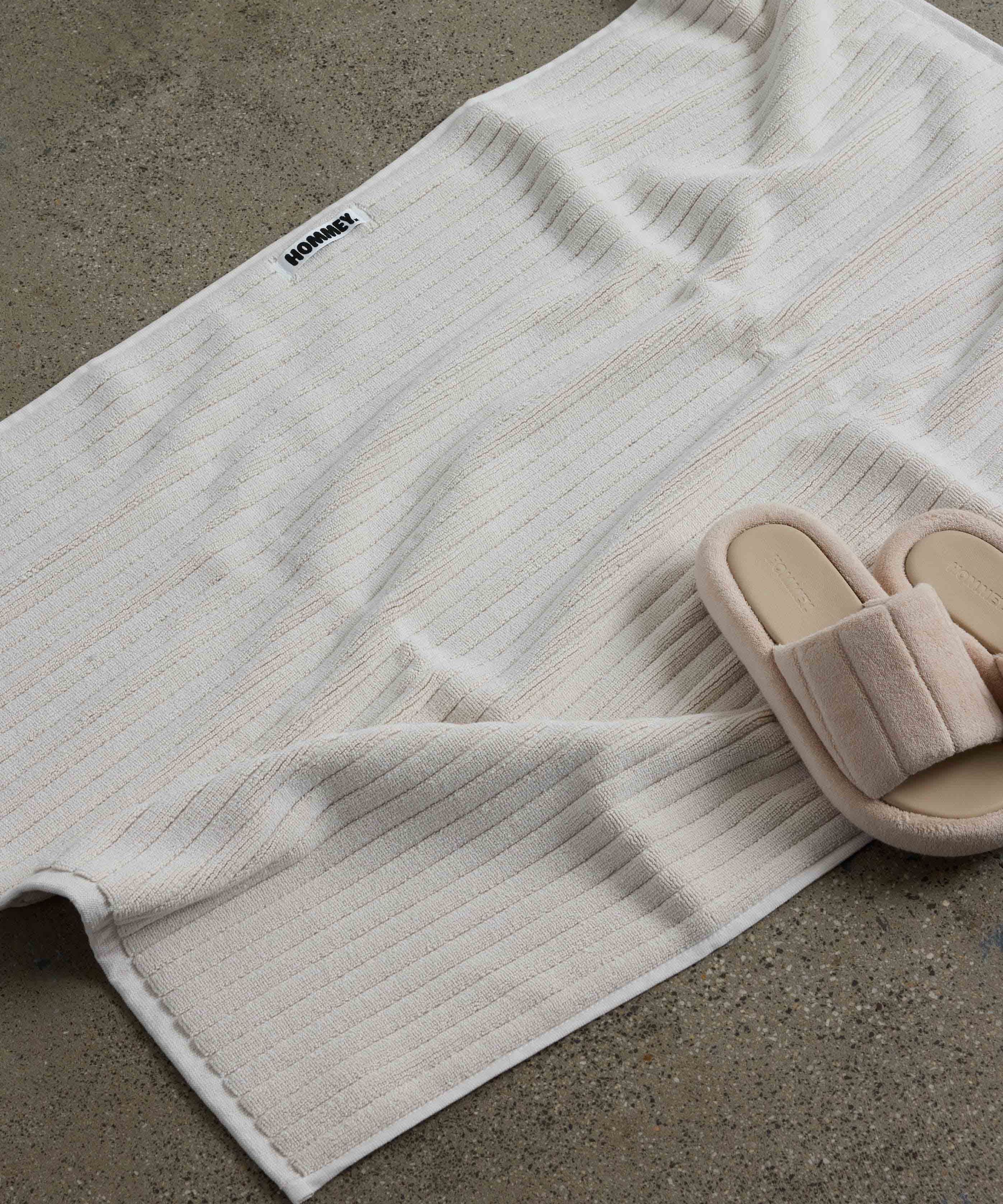 shoes next to white bath mat