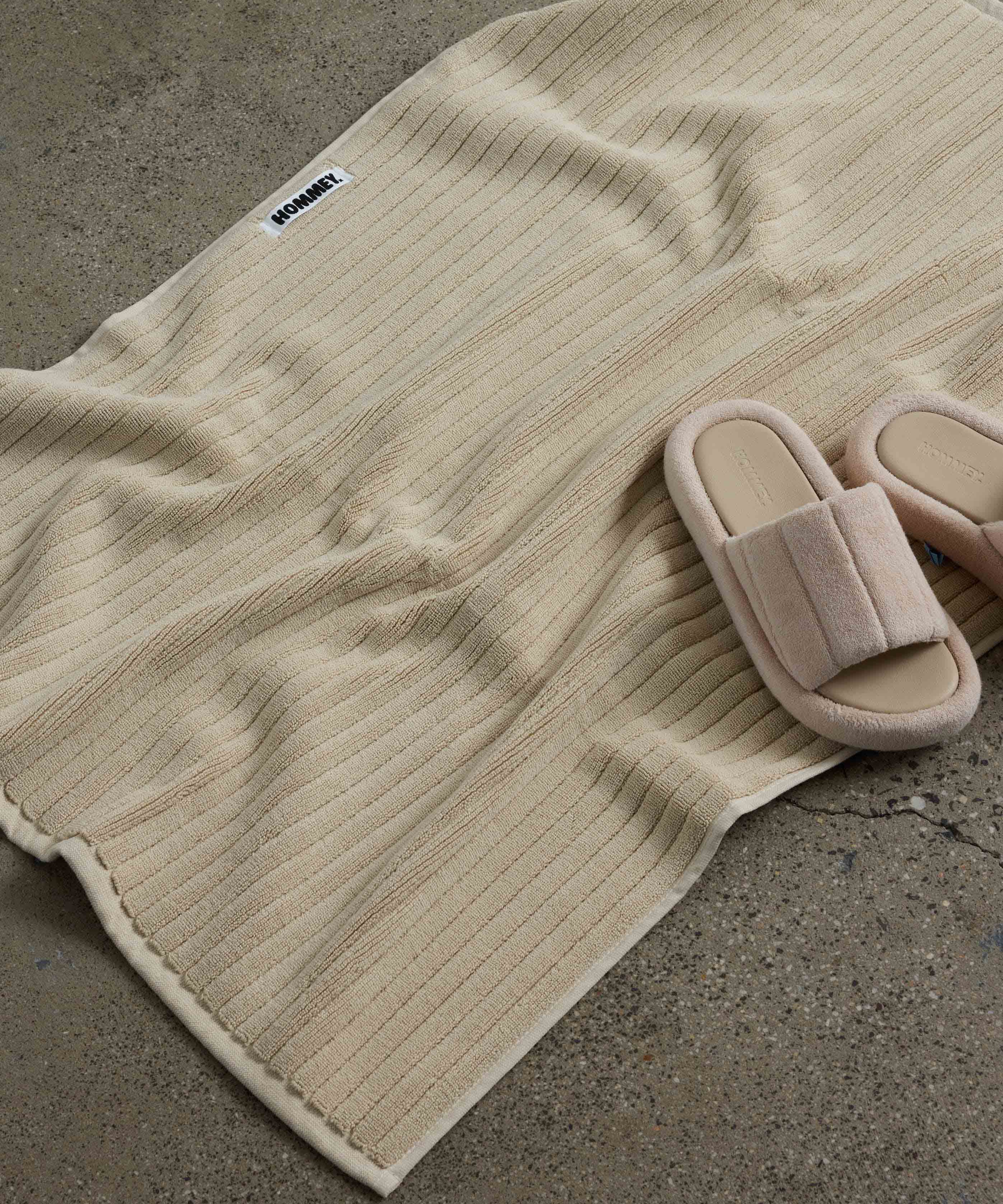 shoes next to beige bath mat