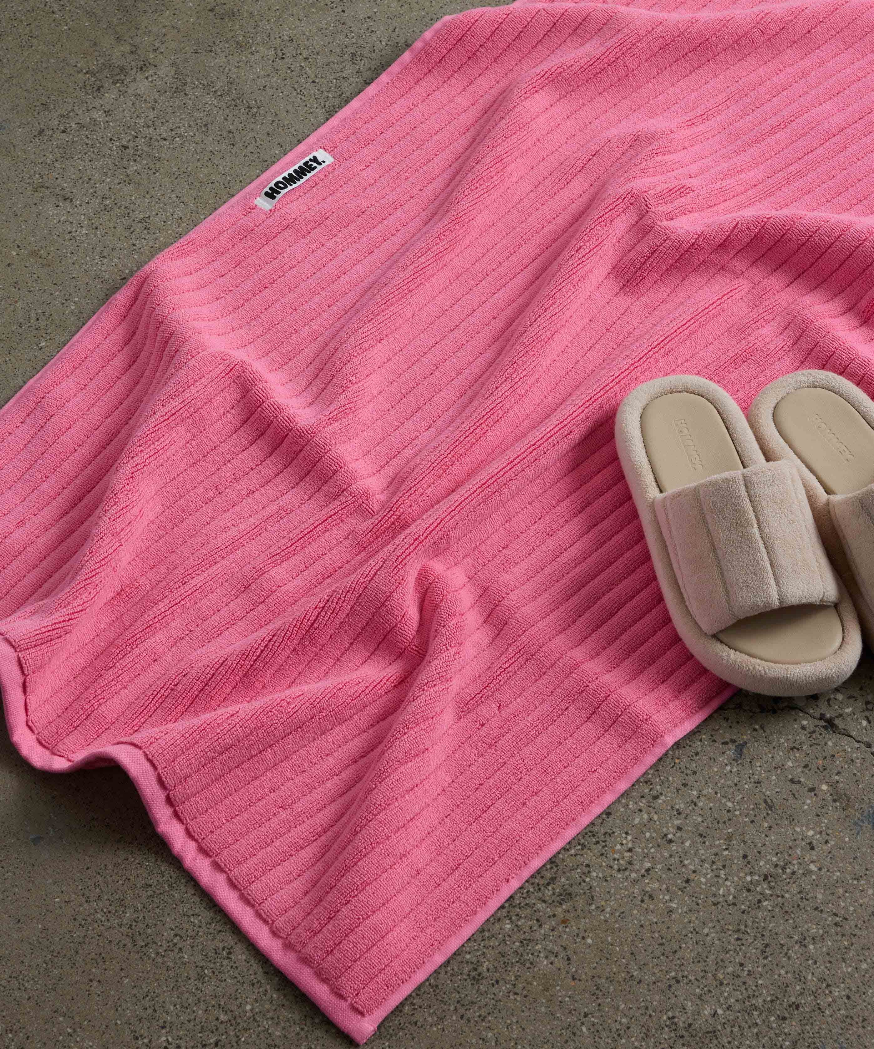 shoes next to pink bath mat