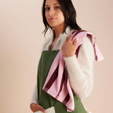 woman has striped pink and red tea towel slung over her shoulder