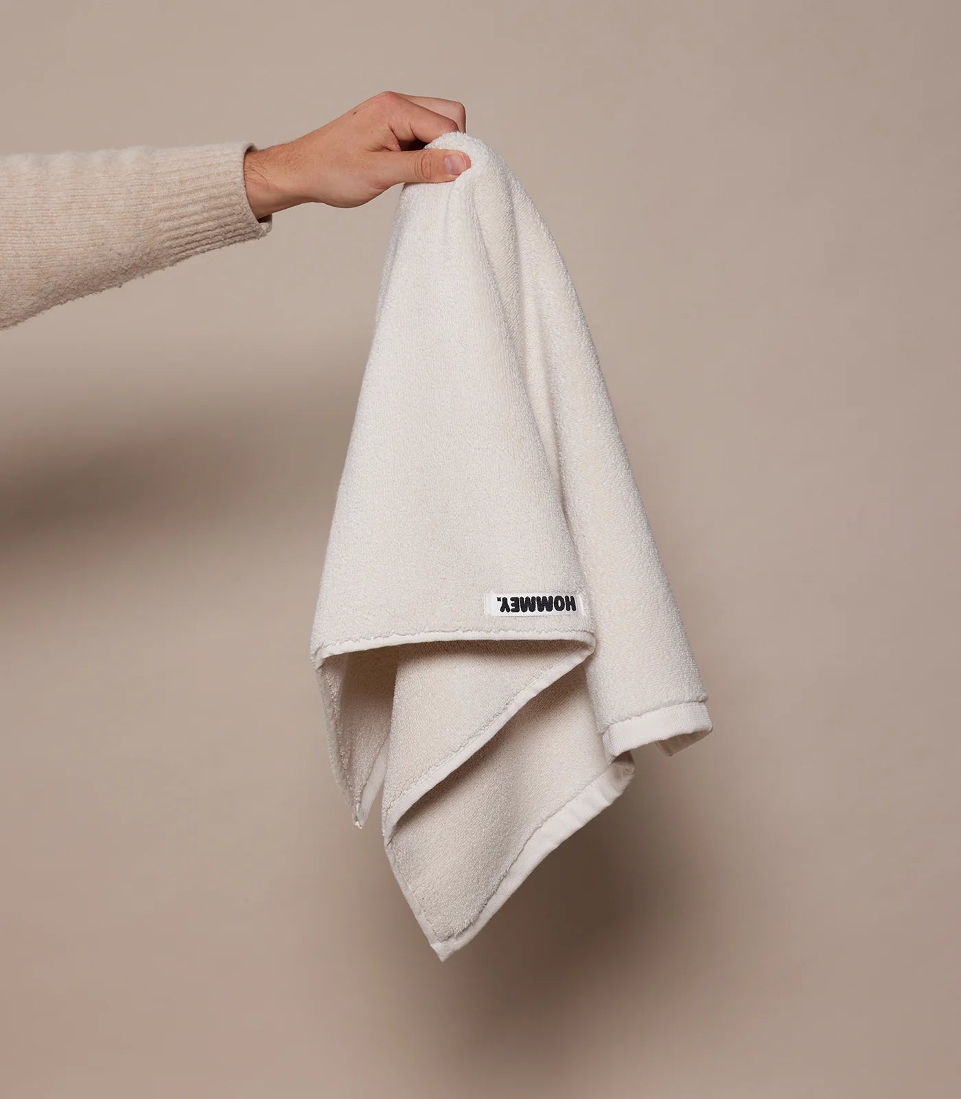 white towel being held up by woman