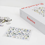 puzzle set of flowers lying down on white background with puzzle completed