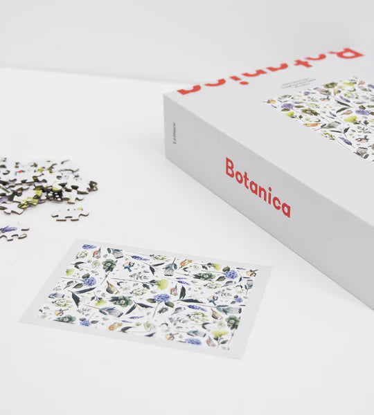 puzzle set of flowers lying down on white background with puzzle completed