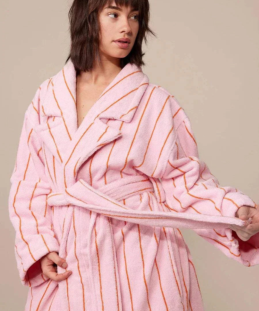 woman standing with bath robe on