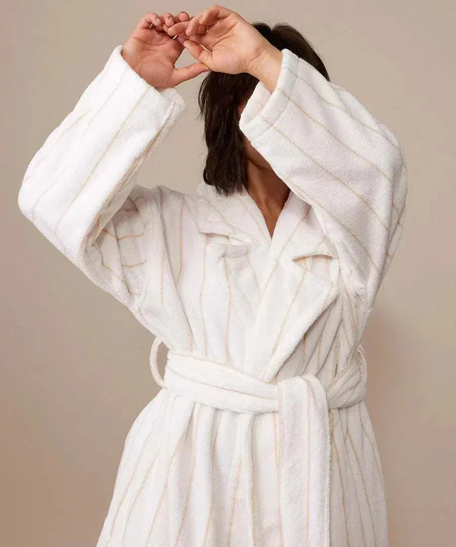 woman with bath robe with arms up