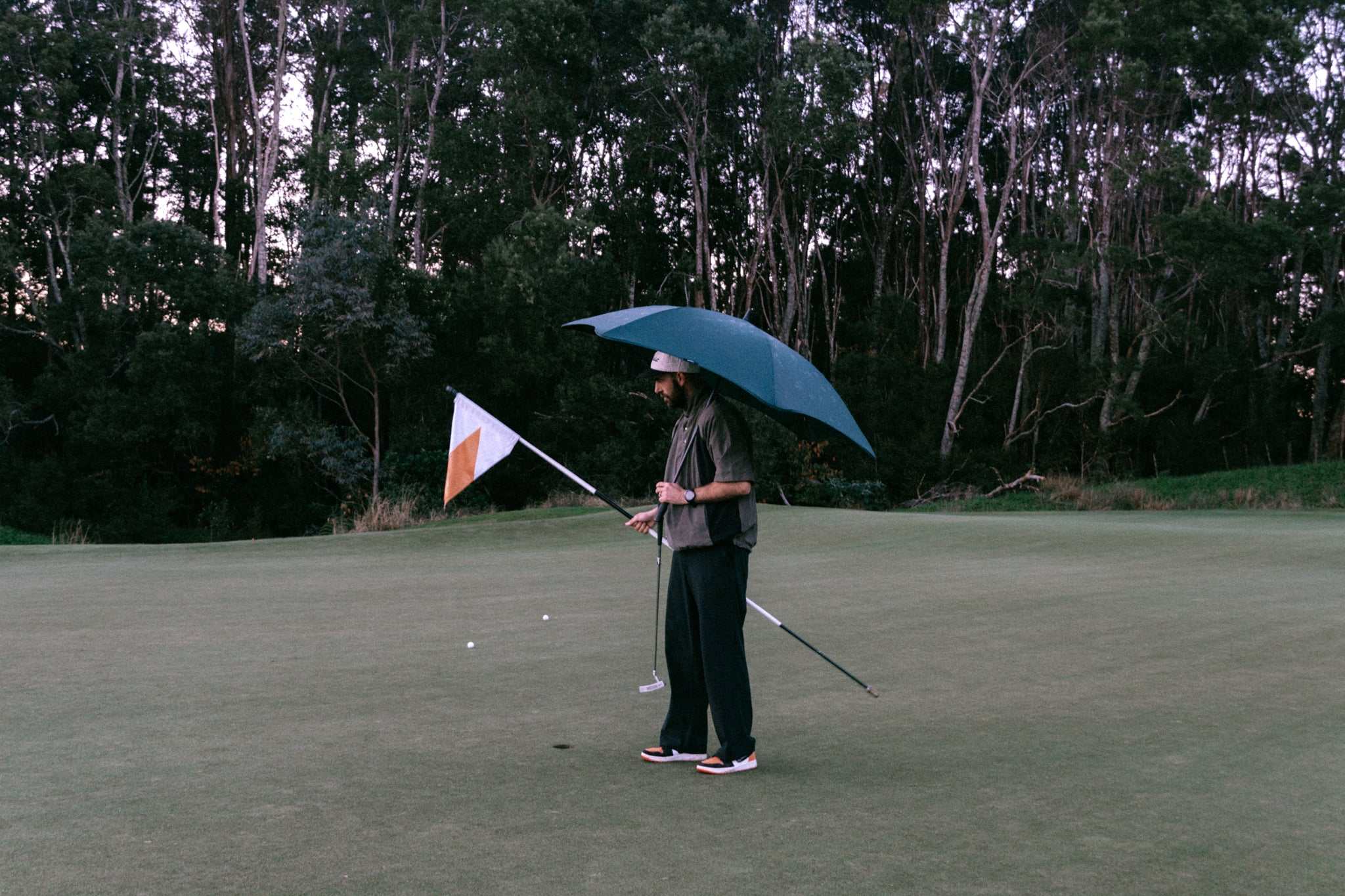 man walking around with umbrella