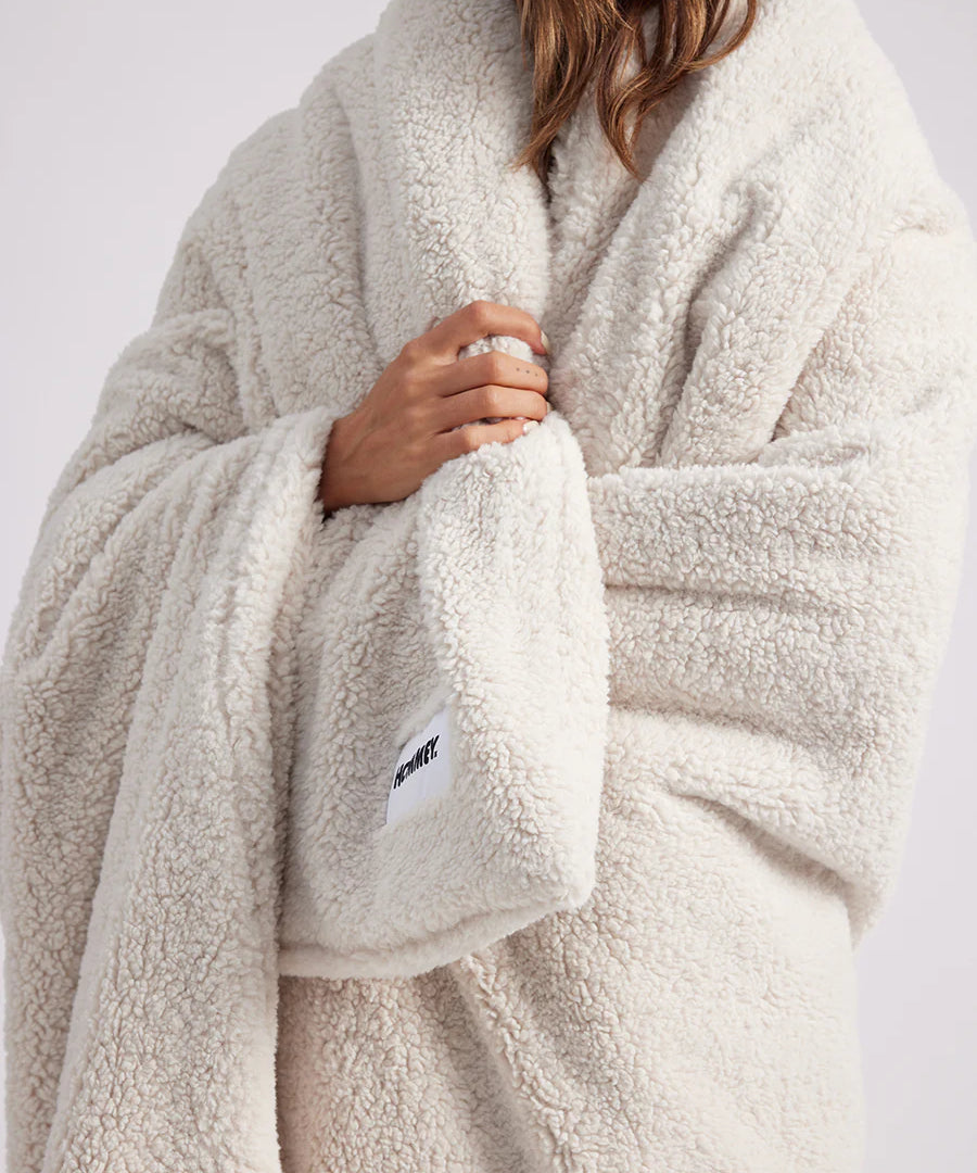 girl wrapped up with a white throw blanket