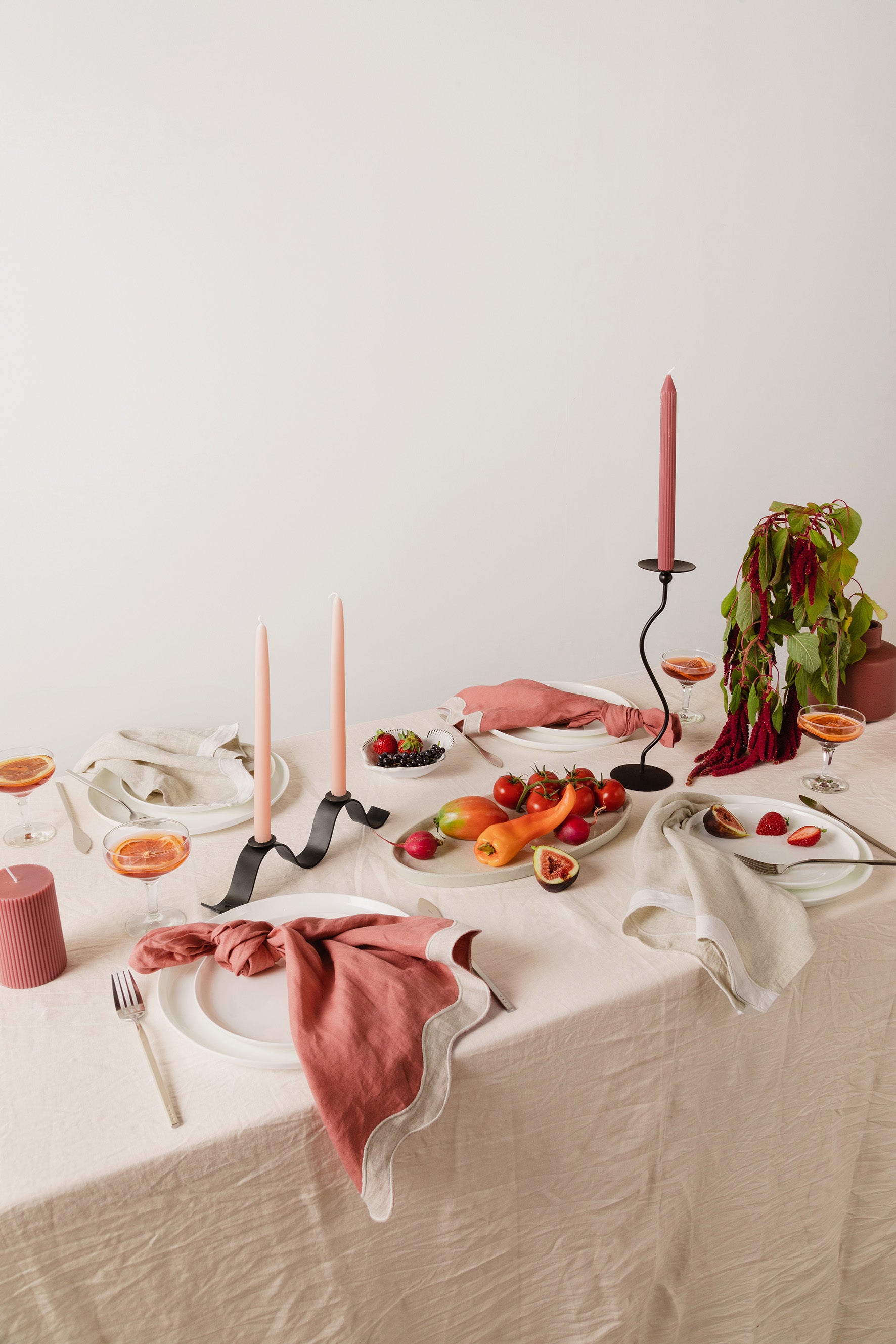 tablescape with food, candles, napkins and ceramics