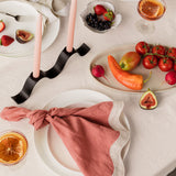 tablescape of food, wavy napkins, and ceramics