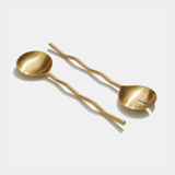 Matte brass wave salad servers with unique hand-cast finish and wavy design.