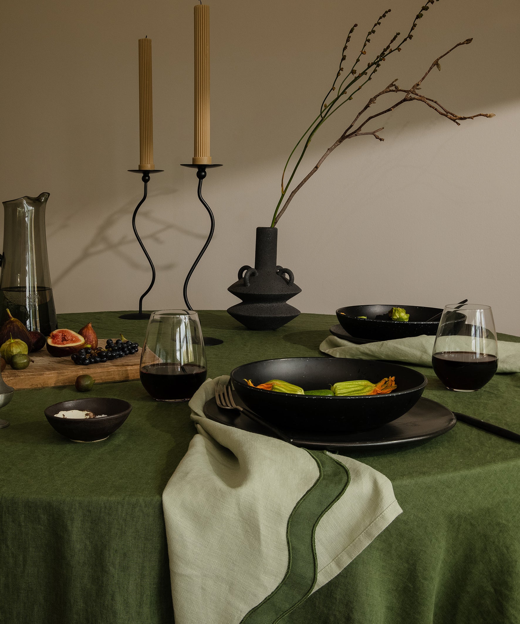 tablescape of food, napkins and other items sitting on table with a green theme
