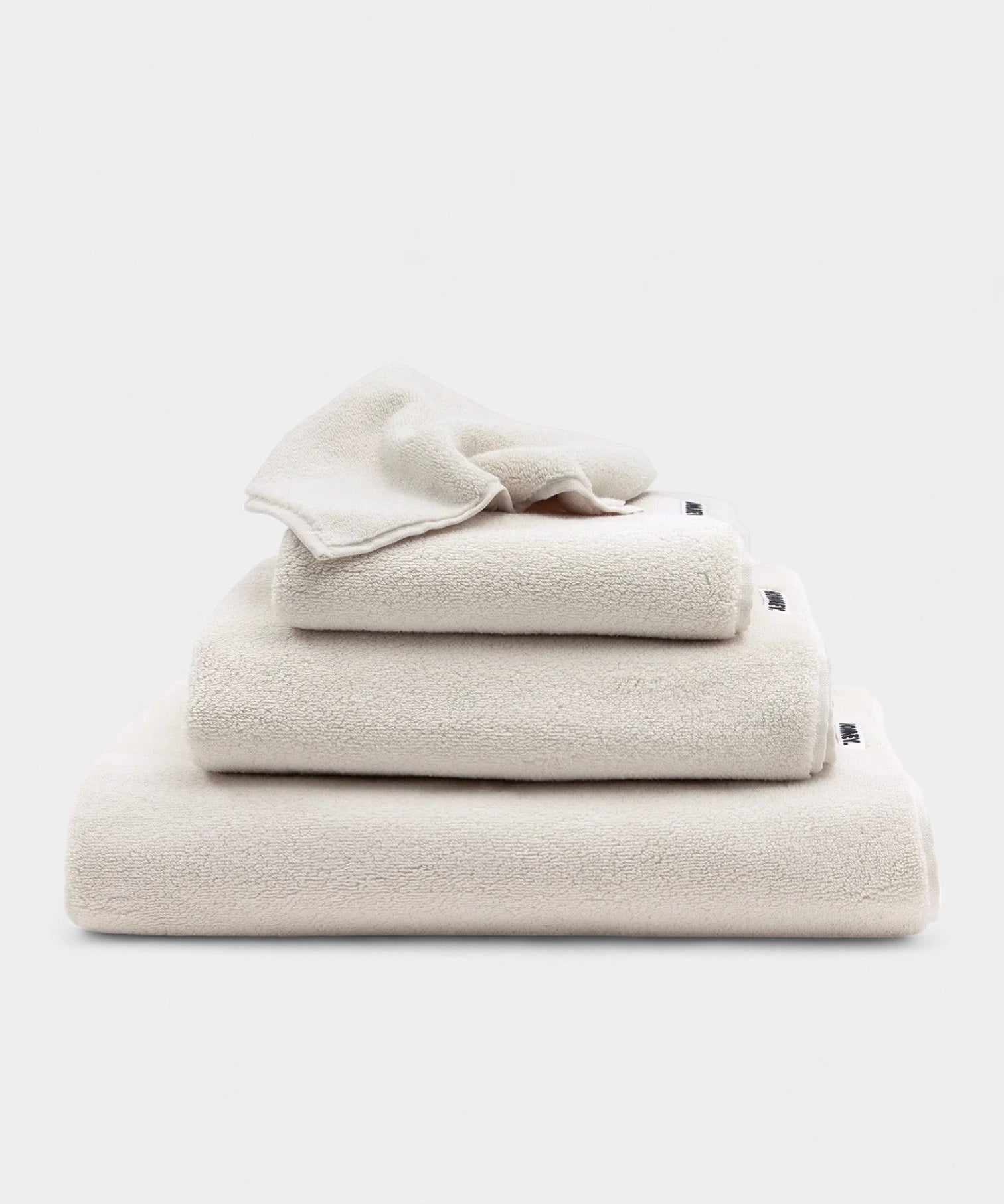 Classic bath towel set in soft milkshake color stacked neatly for everyday spa-like comfort and durability