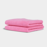 Soft pink hand towel folded neatly for a spa-like home experience