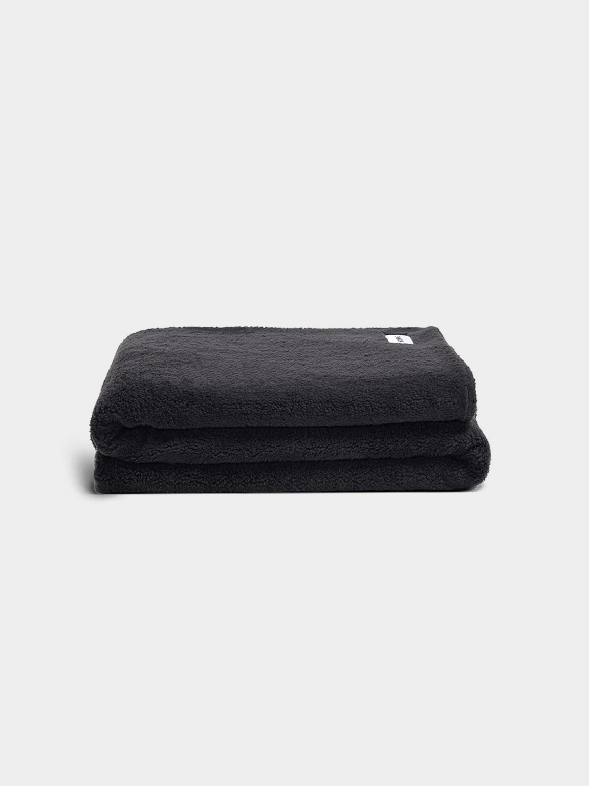 Charcoal faux fur throw blanket folded, ultra-soft vegan plush, 150cm x 210cm, cozy winter comfort