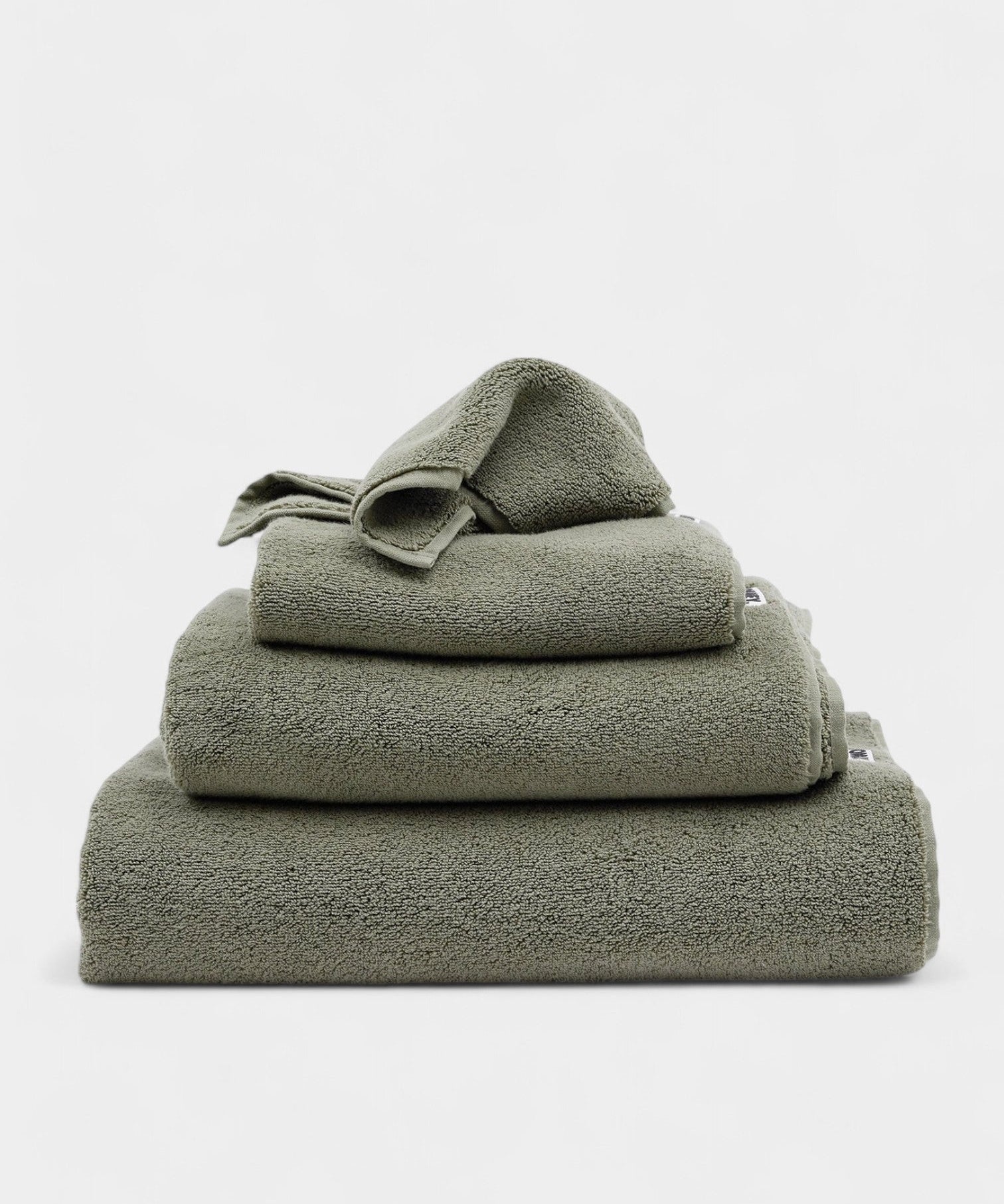 Essentials Bath Towel Set in sage color, soft and durable towels stacked neatly for everyday spa-like comfort.