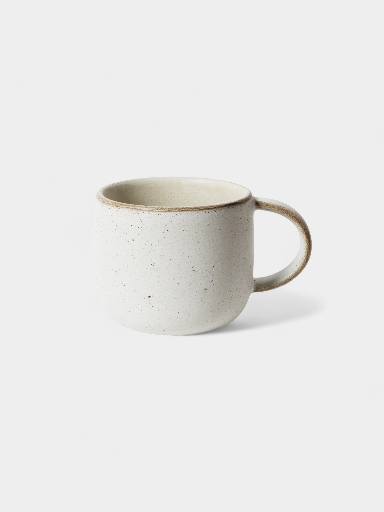 Set of four limestone mugs with a comfortable handle and speckled design for everyday use