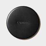 Black round Lumira candle lid for preserving fragrance and protecting candle surface