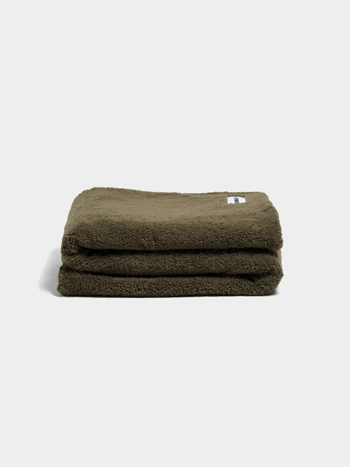 Olive green faux fur throw blanket folded on white background