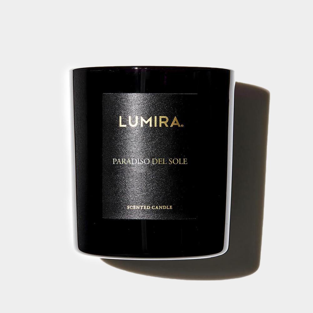 Black Lumira Paradiso del Sole scented candle with gold lettering and shadow on white background