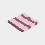 Folded pink and brown striped cotton tea towel with Hommey label