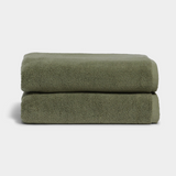 Stacked sage green bath towels with soft texture for a spa-like experience