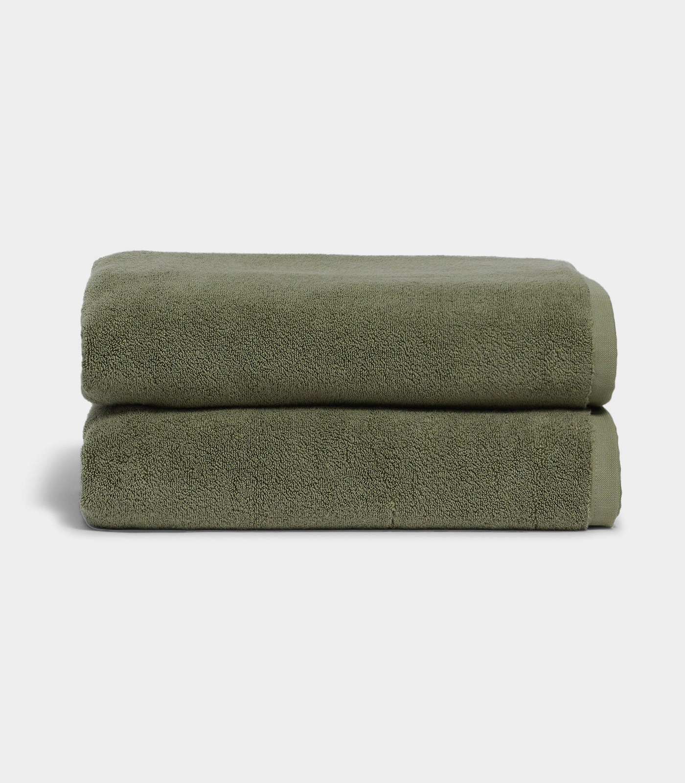 Stacked sage green bath towels with soft texture for a spa-like experience
