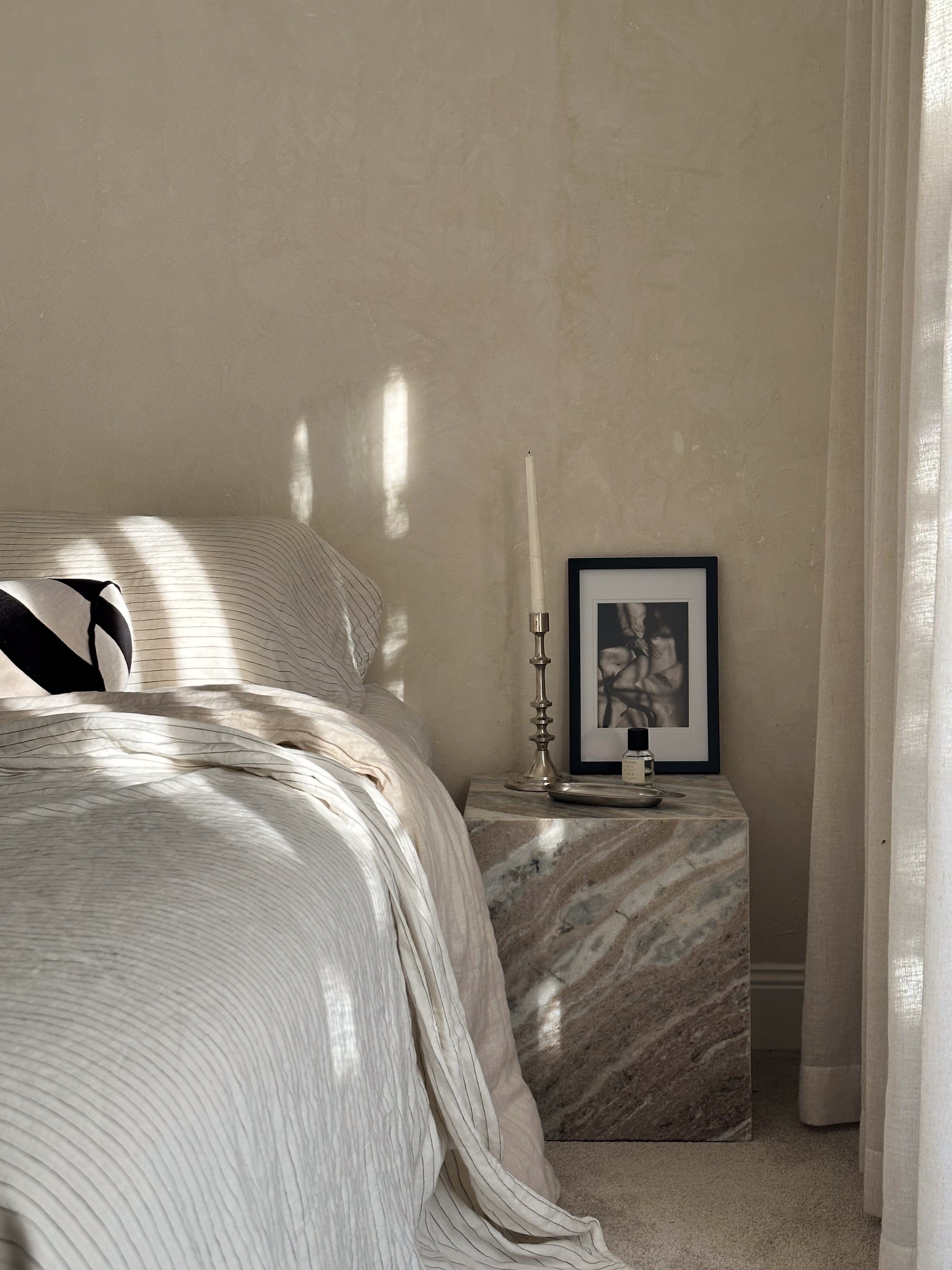 image of a bedside table and a bed
