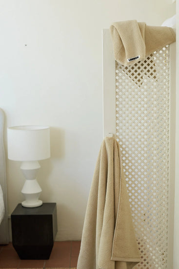 beige face washer towel hanging up