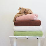 different coloured towels sitting in stack 