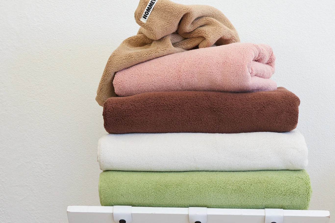 different coloured towels sitting in stack 