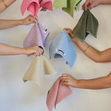 many people holding up different coloured towels