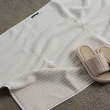 shoes next to white bath mat