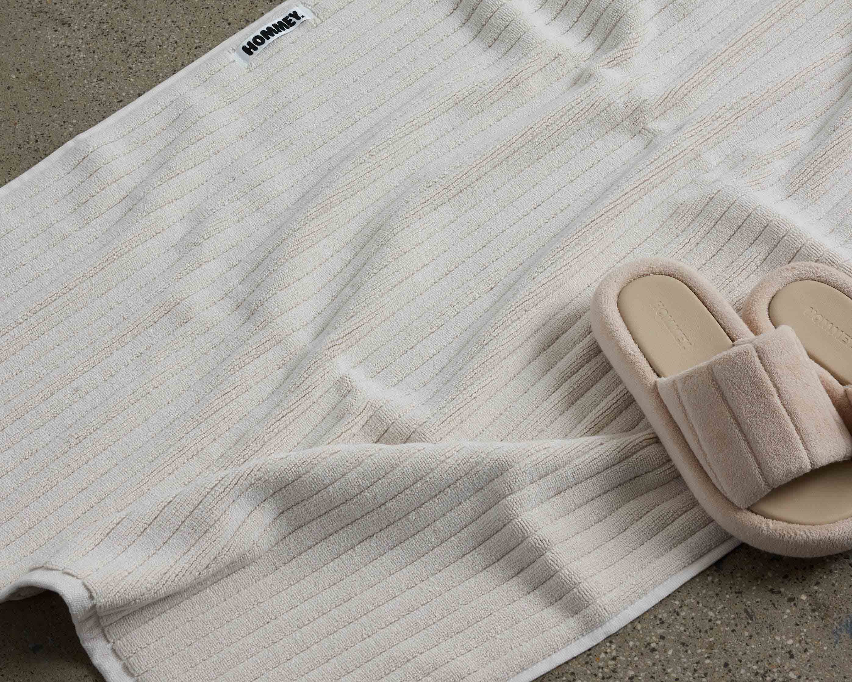 shoes next to white bath mat