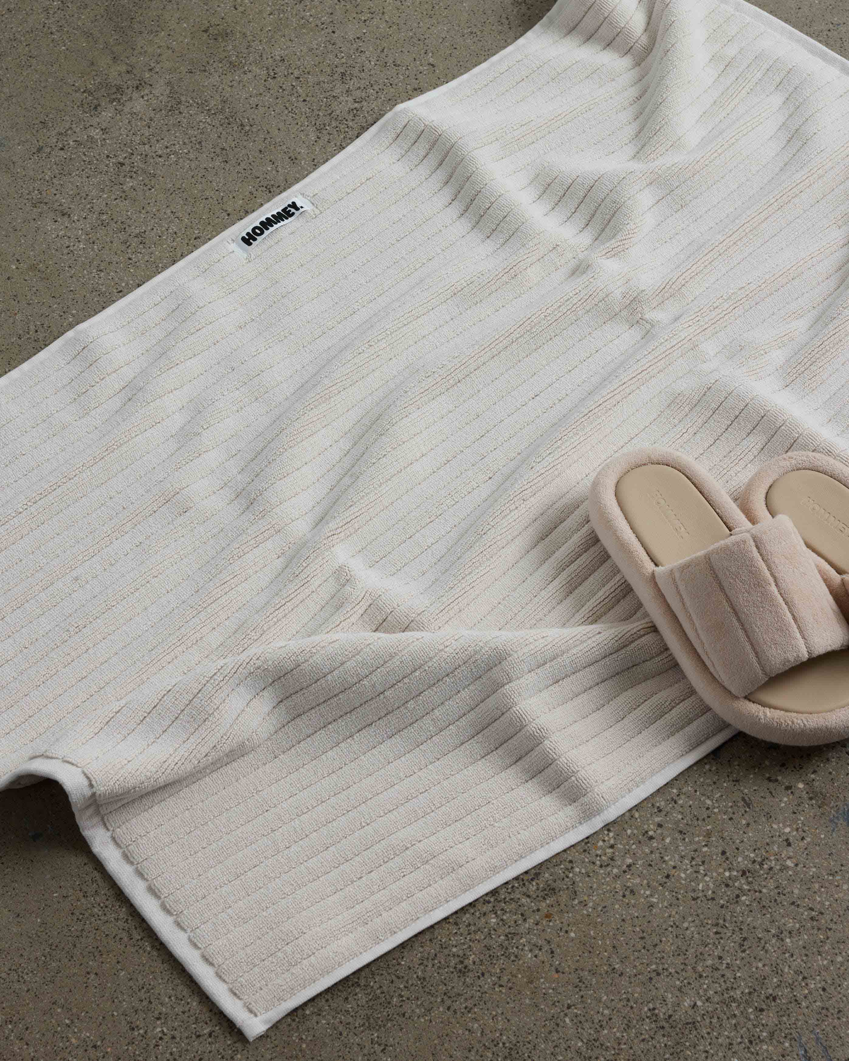 shoes next to white bath mat