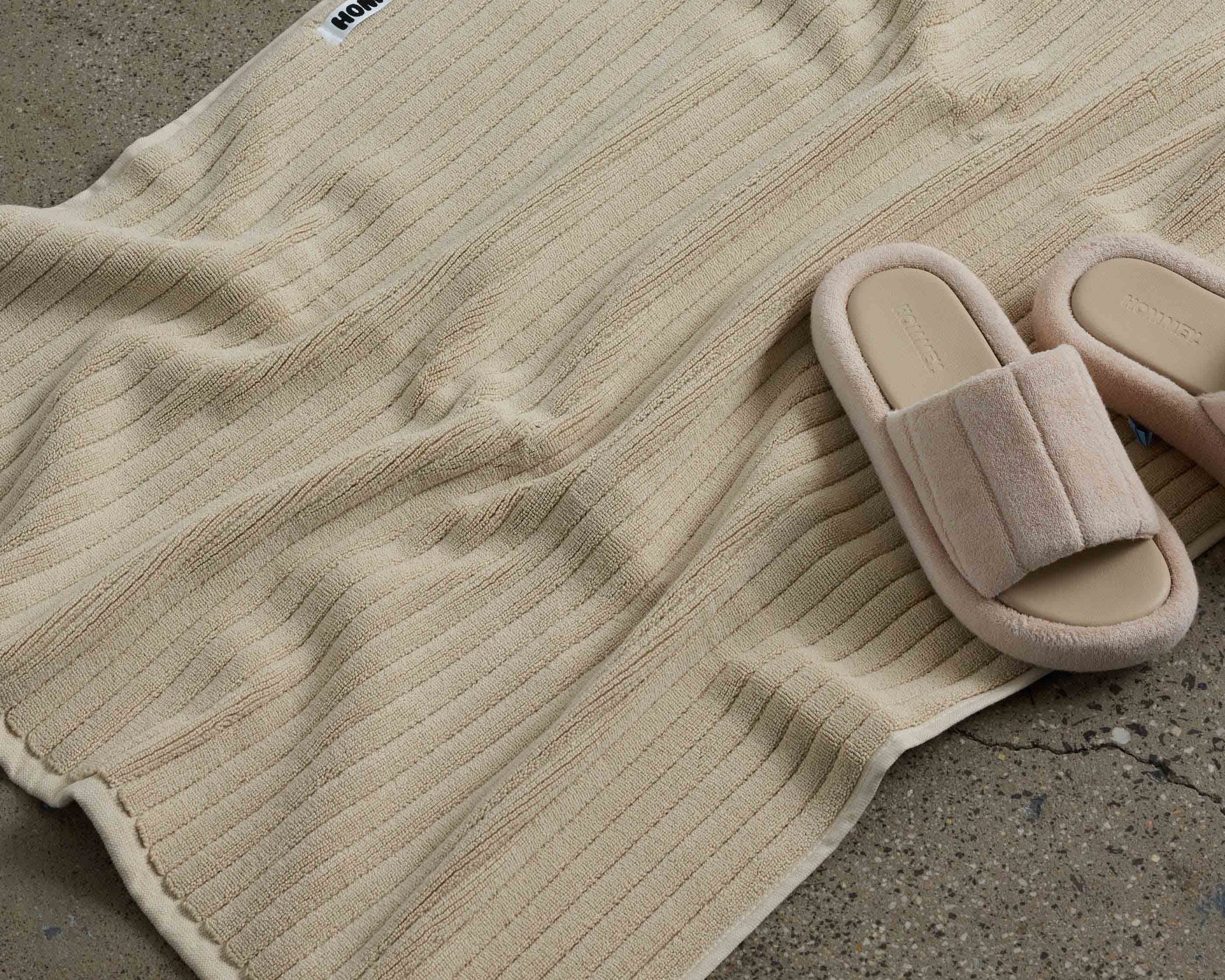 shoes next to beige bath mat