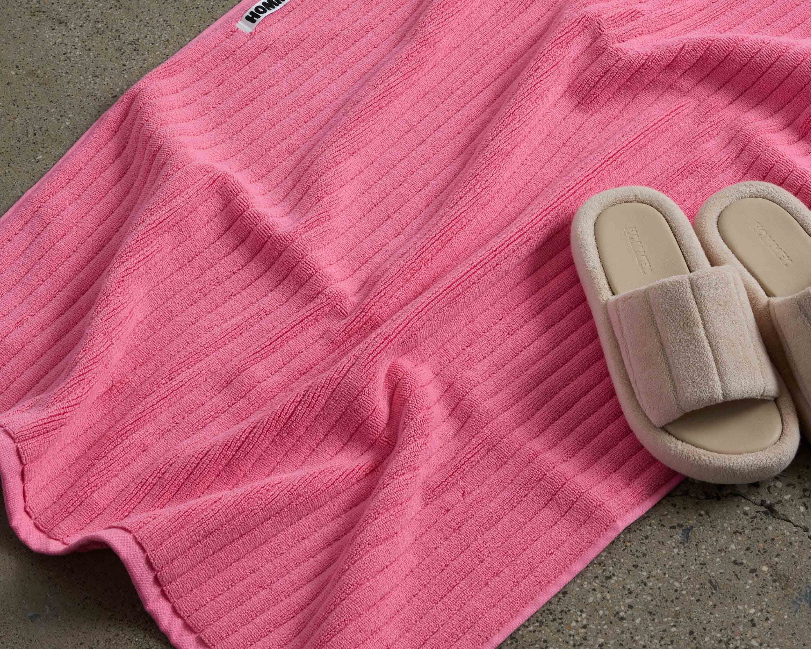 shoes next to pink bath mat
