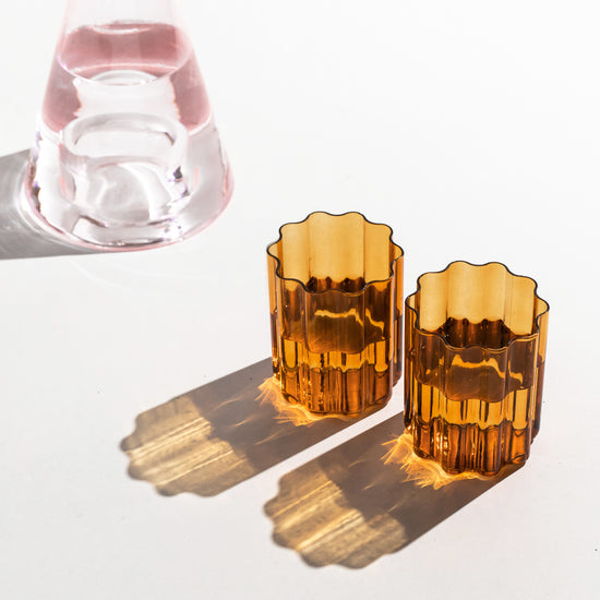 editorial shot of amber wave glasses sitting on table