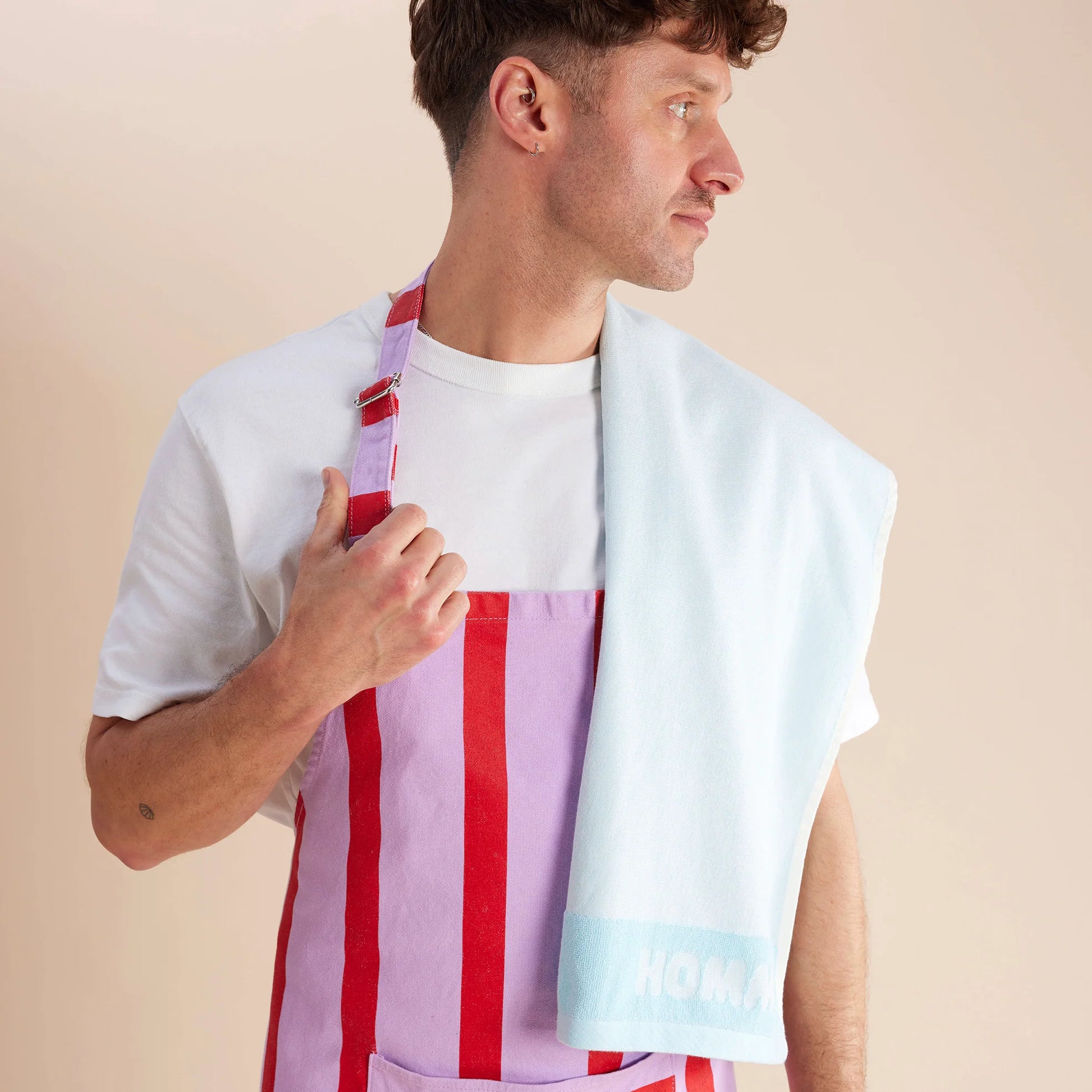 guy standing in purple and red apron