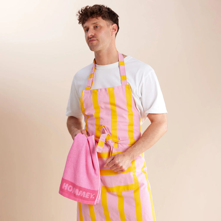 guy standing in pink and yellow striped apron 