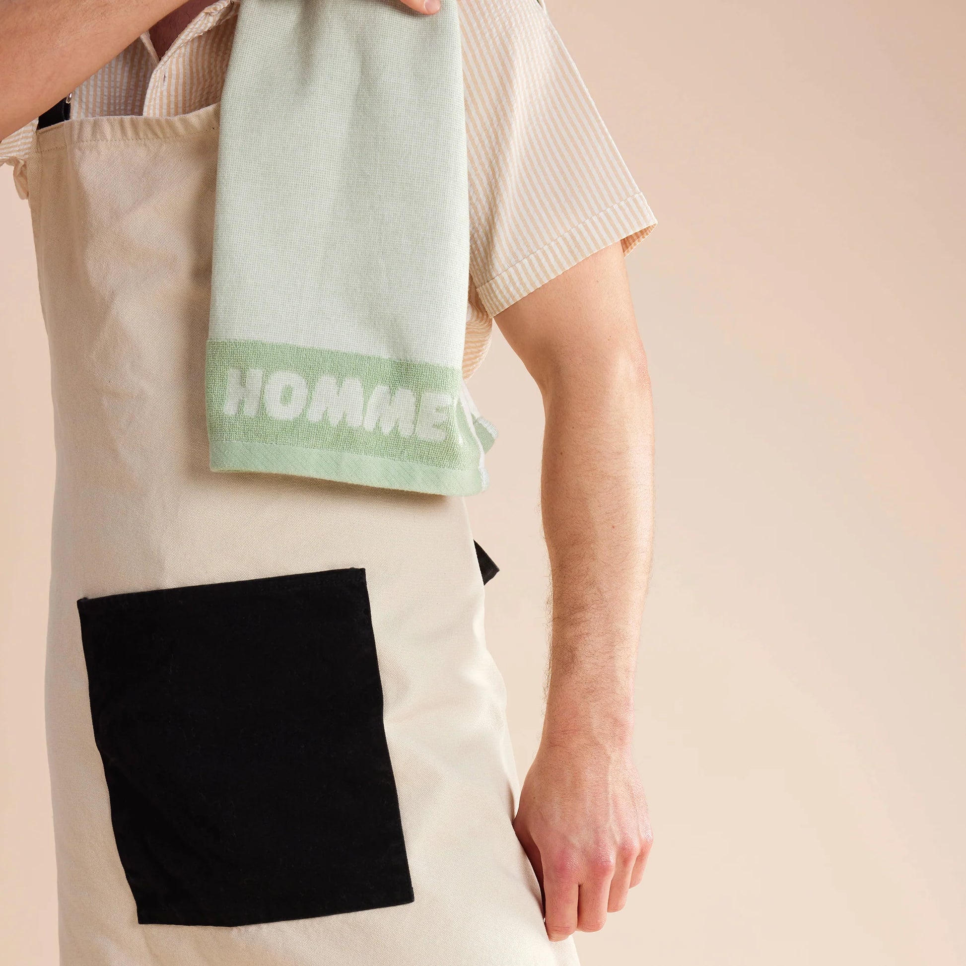 close up shot of guy standing in white and black apron