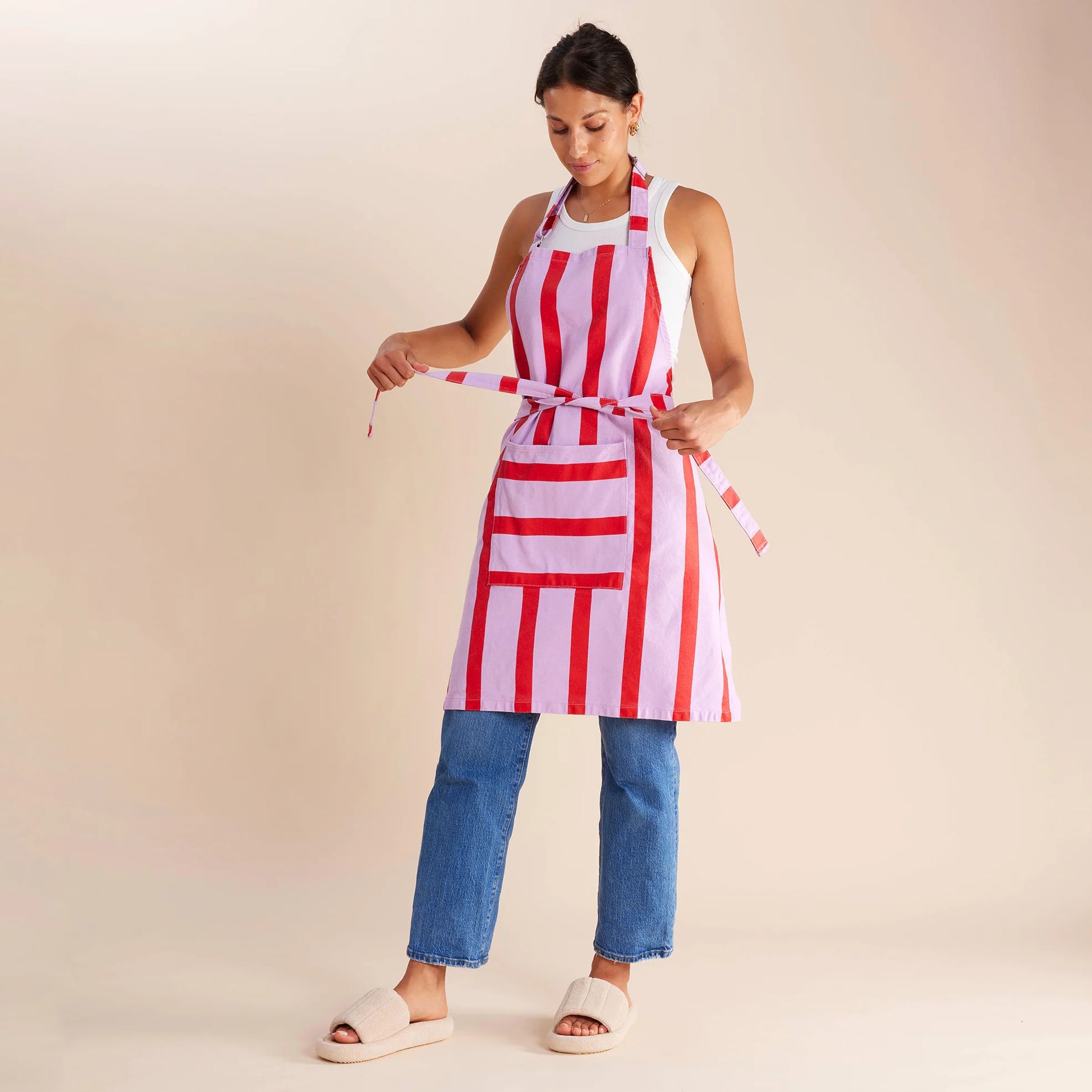 woman standing in purple and red apron