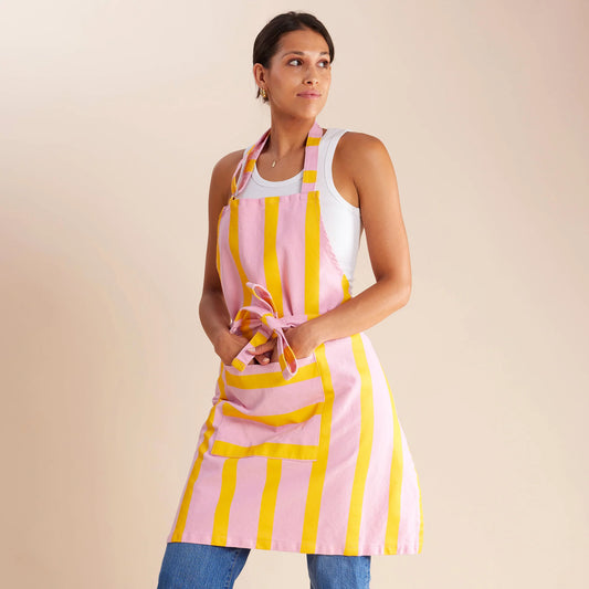 woman standing in pink and yellow striped apron 