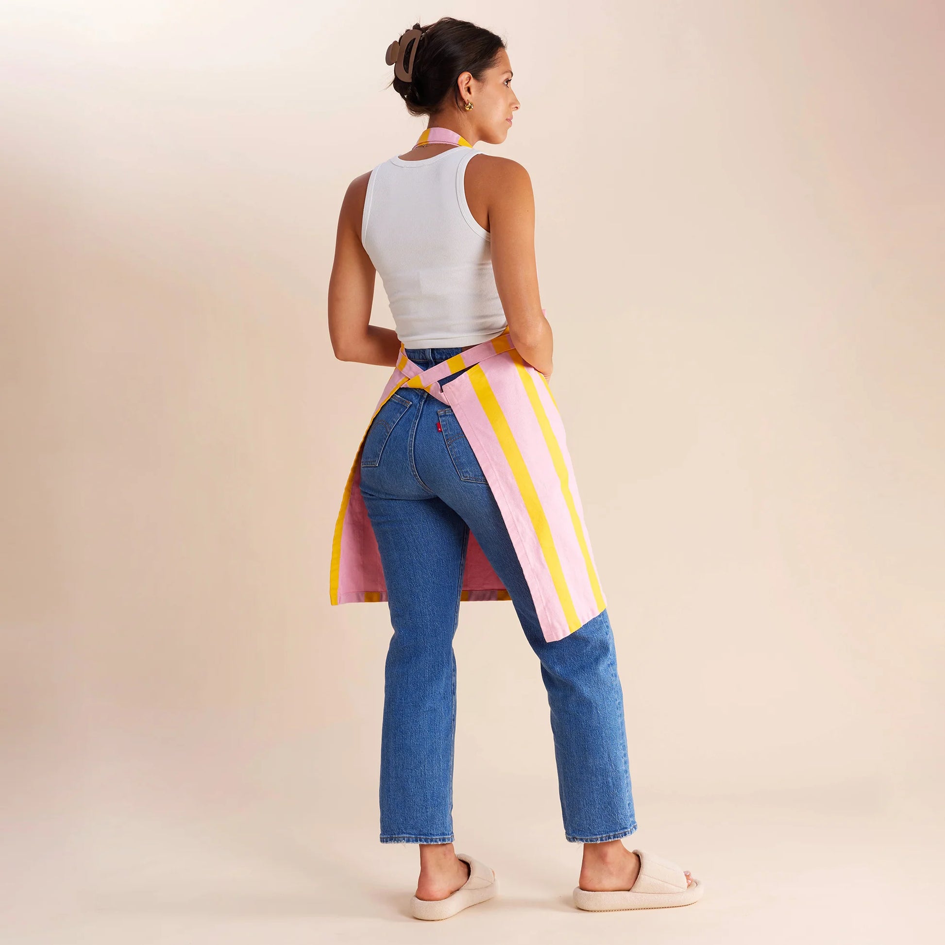 woman standing in pink and yellow striped apron 