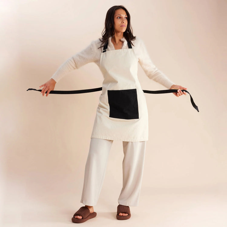 woman standing in white and black apron