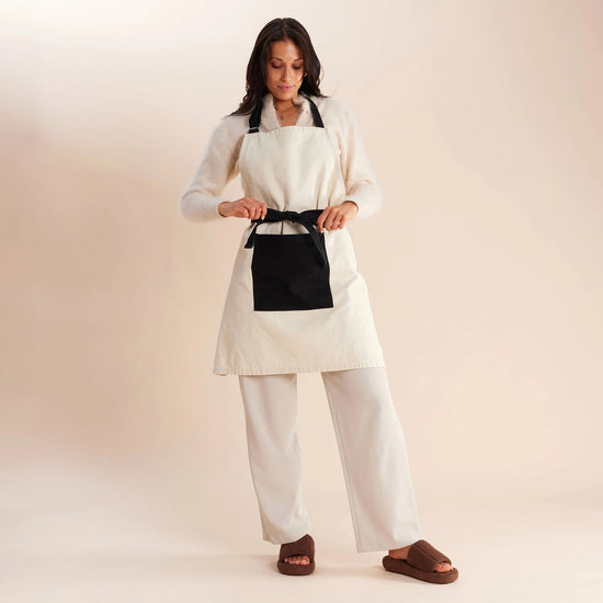 woman standing in white and black apron