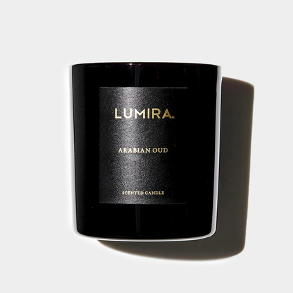Black Lumira Arabian Oud scented candle in glossy container with gold lettering and shadow on white background